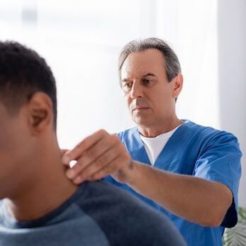 A doctor performs a diagnostic test on a patient with neck pain.